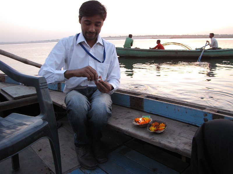 gids ganges.jpg - In de ochtend worden we opgepikt door onze gids. Samen met hem gaan we een tocht over de Ganges maken.Hier maakt hij de drijvende kaarsjes klaar die wij in de ganges mogen zetten.